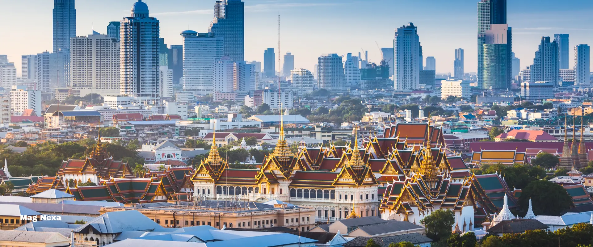 Bangkok — the gilded spires of the Grand Palace against the modern city skyline
