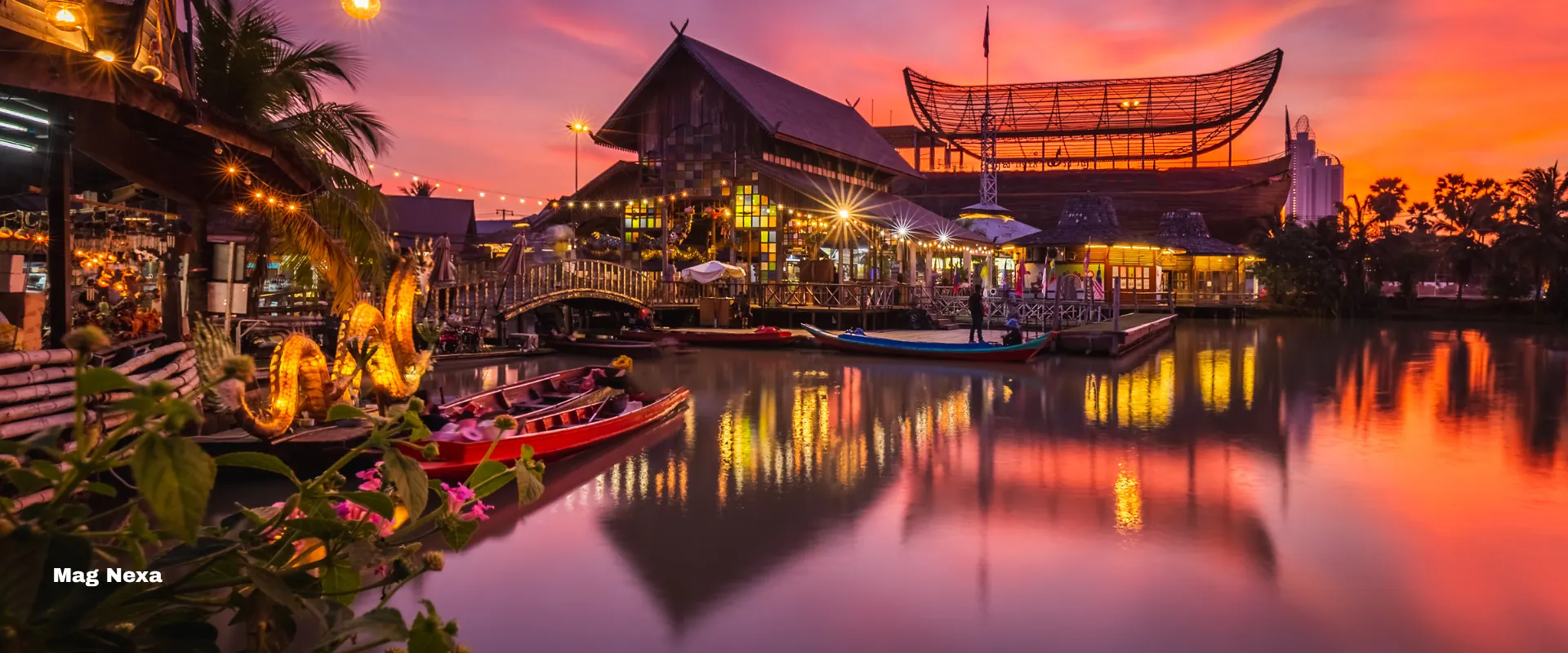 Pattaya — the floating market at sunset, teak pavilions and longtail boats lit on still water