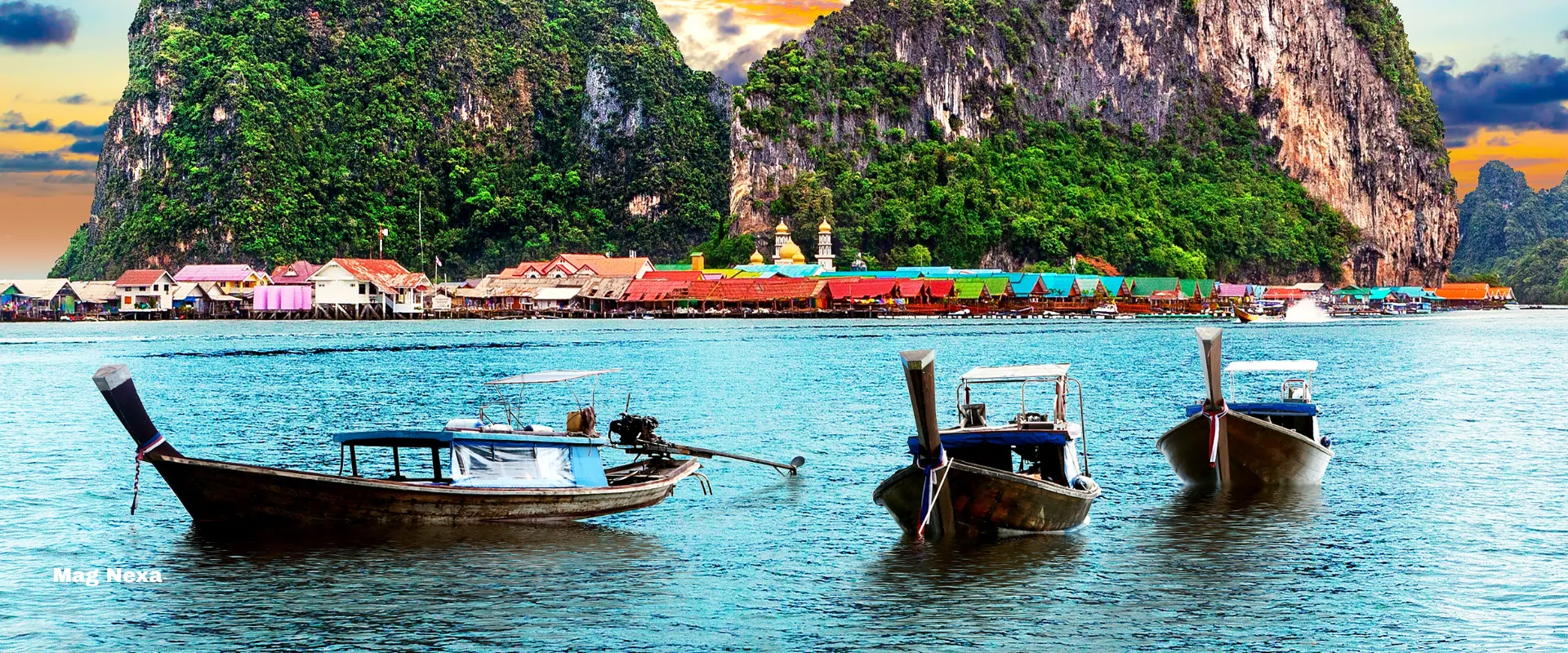 Phuket — longtail boats moored off a floating village beneath towering limestone karsts